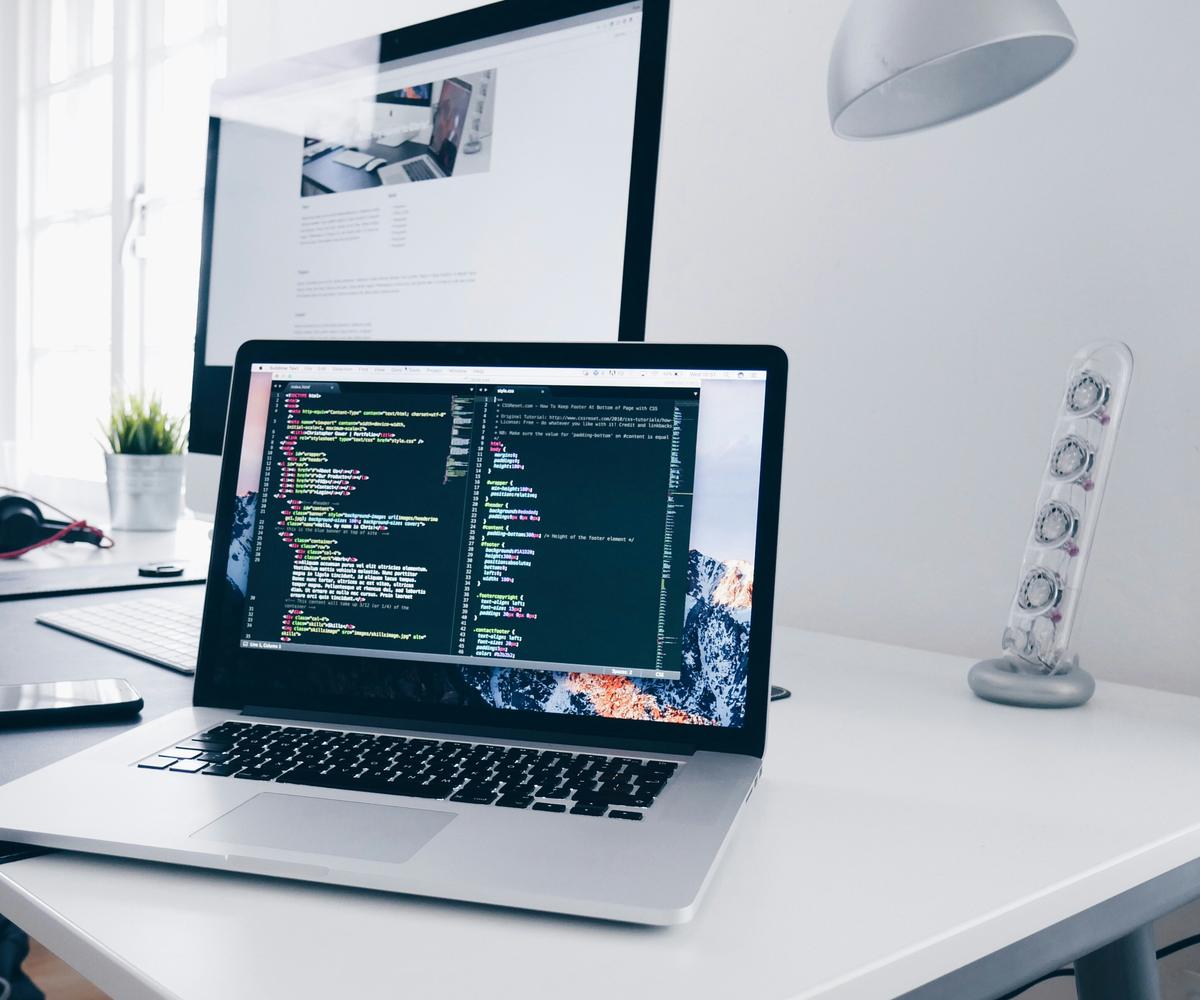 Developer workstation with code on a laptop screen